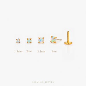 May include: Gold-coloured stud earrings with iridescent opal stones in sizes 1.5mm, 2mm, 2.5mm, and 3mm. A single gold labret stud is also shown. The text "SHEMISLI JEWELS" is at the bottom of the image.