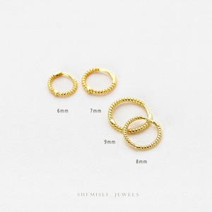 May include: Four gold hoop earrings in sizes 6mm, 7mm, 8mm, and 9mm. The earrings feature a twisted rope design. The brand name "SHEMISLI JEWELS" is visible at the bottom of the image.