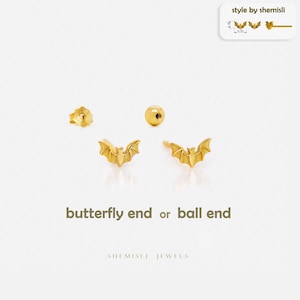 May include: Gold-coloured bat-shaped earrings with butterfly and ball end options. The image shows the earrings, along with a butterfly back and a ball back. The text reads "butterfly end or ball end" and "SHEMISLI JEWELS".