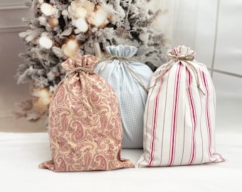 Reusable fabric gift bags in ticking, gingham or paisley cloth with a rustic rope drawstring in Farmhouse style size 10 x 15