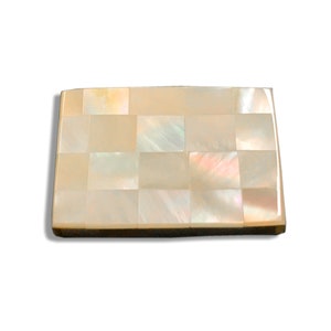 May include: A rectangular tray made of mother of pearl tiles. The tiles are arranged in a checkered pattern and have a light beige color with iridescent highlights.