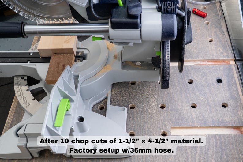 May include: A close-up of a gray and green power saw with a wood block in the blade. The saw is on a gray surface with holes. The text "After 10 chop cuts of 1-1/2" x 4-1/2" material. Factory setup w/36mm hose." is below the saw.