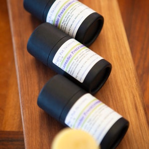May include: Three black tubes with white labels containing natural deodorant. The labels have the text "Magnu Fat Skincare" and "Lavender Frankincense" on them.