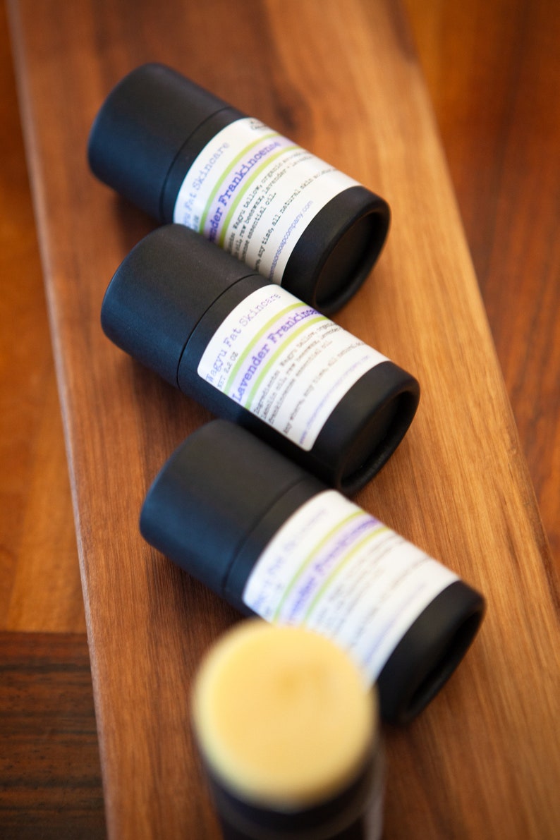 May include: Three black tubes with white labels containing natural deodorant. The labels have the text "Magnu Fat Skincare" and "Lavender Frankincense" on them.