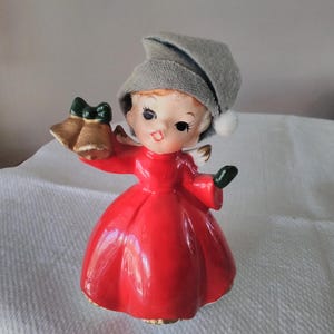Norcrest ceramic Christmas angel with bells, cloth hat, just under 5&quot; tall, excellent vintage condition, original foil paper label, no chips