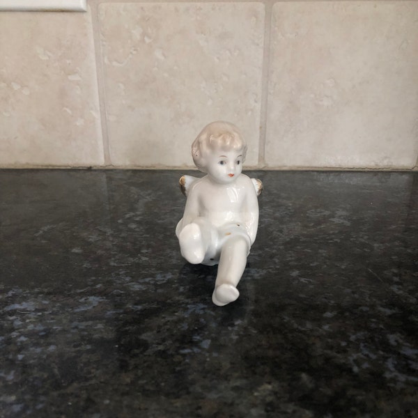 Sweet little vintage Angel Figurine measuring 3.3" x 3" x 2.5.  this darling angel is on his back with feet in the air, different and unique