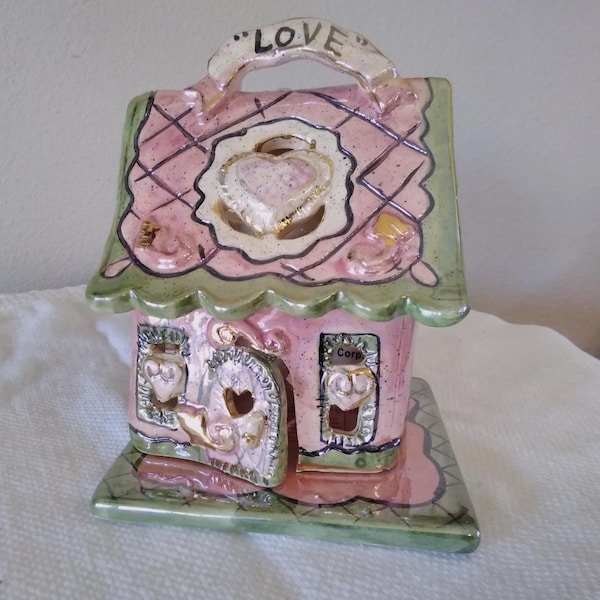 Heather Goldminc whimsical Love Country Cottage ceramic sculpture tea light holder, marked Blue Sky Corp. ©2001, pink, green, gold luster
