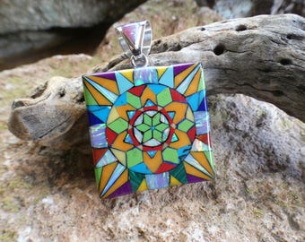 May include: A square pendant with a colorful geometric design. The pendant is made of various stones and is set in silver.
