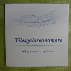 May include: A white business card with a blue feather design and the text "Tilesgaloreandmore" and "eBay.com~Etsy.com".