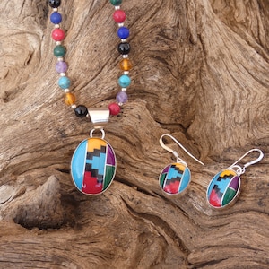 May include: A multi-colored stone pendant necklace and matching earrings. The pendant and earrings feature a geometric design with turquoise, red, yellow, green, and black stones.