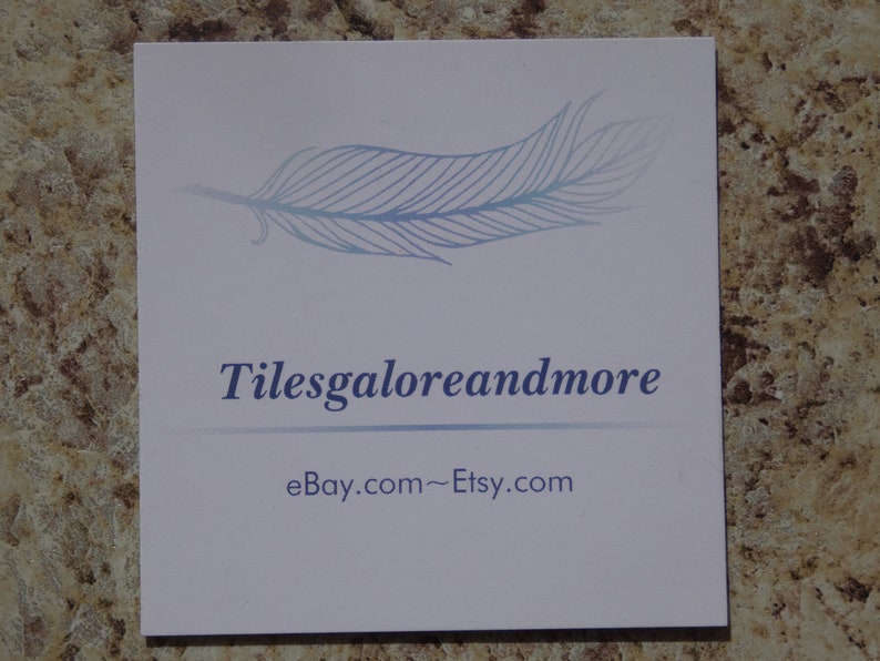 May include: A white business card with a blue feather design and the text "Tilesgaloreandmore" and "eBay.com~Etsy.com".