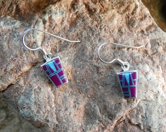 May include: A pair of sterling silver earrings with purple and blue inlay. The earrings are in the shape of a trapezoid and have a geometric design.