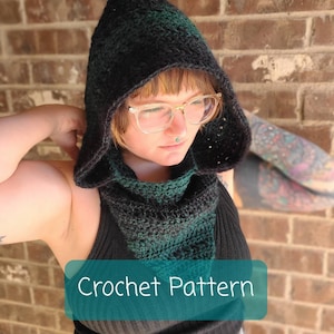 May include: A black and green crochet hooded scarf with a pointed hood. The scarf is worn by a person with glasses and a nose ring. The text "Crochet Pattern" is visible in the image.