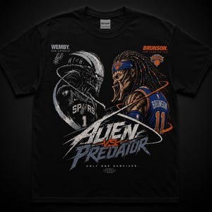 May include: A black t-shirt featuring a graphic of an alien and a predator wearing basketball jerseys. The text reads WEMBY, SAN ANTONIO, BRUNSON, NEW YORK KNICKS, ALIEN VS PREDATOR, and ONLY ONE SURVIVES. The alien wears a Spurs jersey and the predator wears a Knicks jersey.
