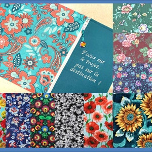 May include: A collage of fabric swatches featuring various floral patterns, including paisley, sunflowers, and daisies. The swatches are arranged in a grid pattern and are all in bright colours. The text "Focus sur le trajet, pas sur la destination!" is embroidered on a teal fabric swatch.