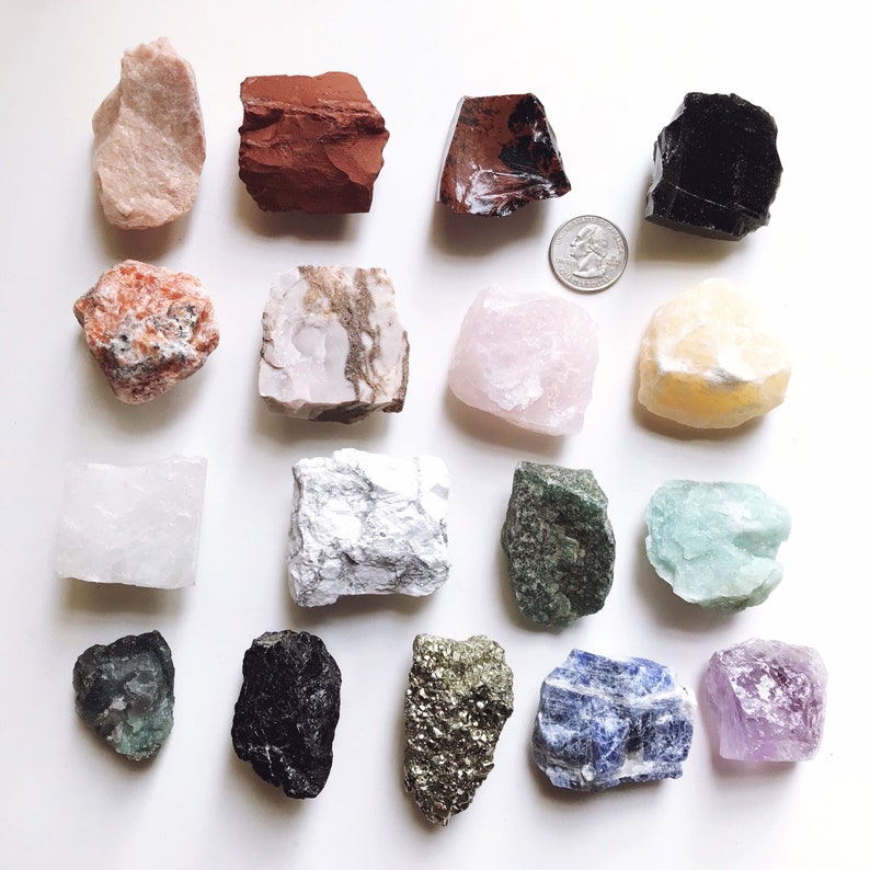 May include: A collection of 15 different types of crystals and stones, including amethyst, rose quartz, clear quartz, citrine, and more. The crystals are arranged in a grid pattern on a white background.