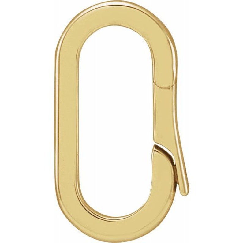 May include: A gold-colored oval-shaped clasp. The clasp has a hinged design for easy opening and closing. The metal has a polished finish, reflecting light.