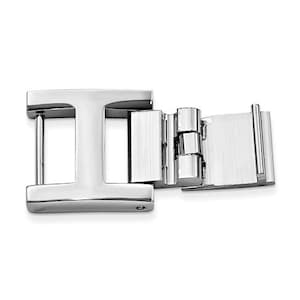 May include: A shiny, silver-colored metal clasp with an 'I' shape on one end and a hinged, rectangular section on the other. The clasp is designed with a polished finish, reflecting light and showcasing its geometric design. The overall aesthetic is modern and minimalist.