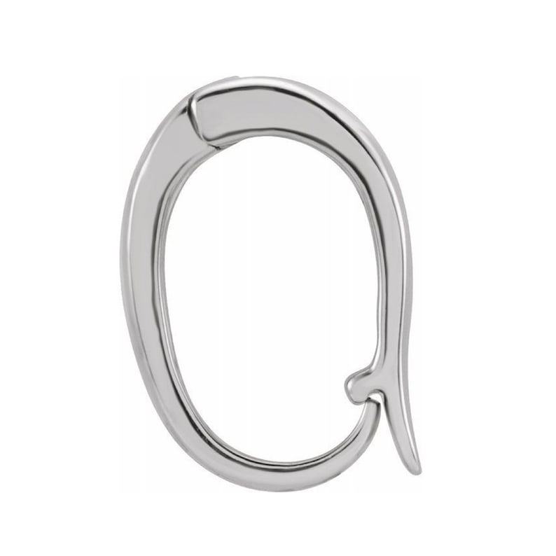 May include: A polished, silver-toned earring clasp. The clasp is oval-shaped with a curved design and a hook closure. The metal has a reflective surface, and the design is simple and elegant. The earring clasp is shown against a white background.