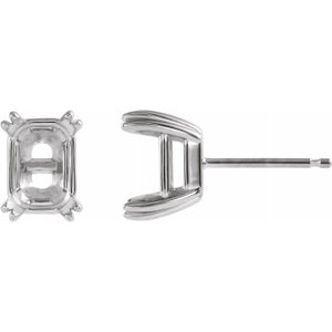 May include: A pair of silver earring settings for an emerald cut gemstone. The settings are designed to hold a stone securely in place.