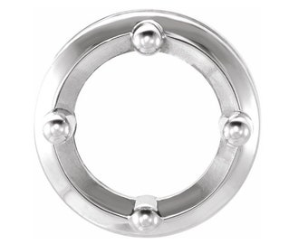 May include: A silver metal ring with four round decorative accents. The ring is smooth and shiny.