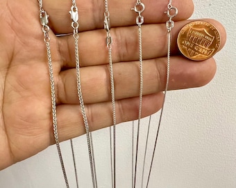 May include: Five silver chains of different thicknesses, ranging from 1.8mm to 0.85mm, are displayed on a hand. The chains are all the same length and are hanging straight down. A penny is included for size comparison.