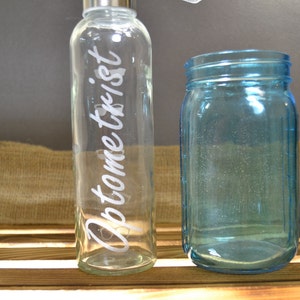 Optometrist etched glass water bottle with glasses drinking levels
