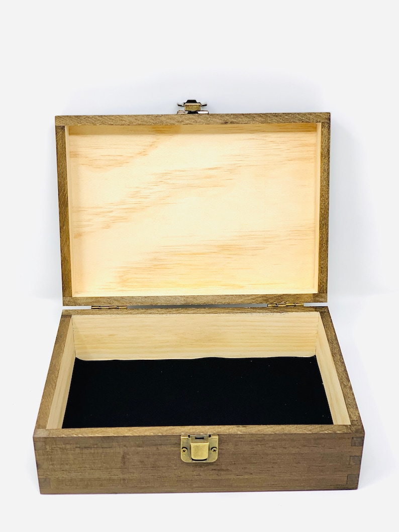 May include: A wooden box with a hinged lid and a brass latch. The box is open and the inside is lined with black velvet.