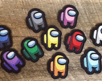 May include: Ten embroidered iron-on patches featuring the Among Us characters in different colors, including blue, red, green, yellow, orange, purple, pink, white, gray, and light blue.