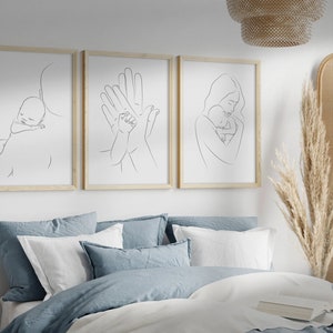 Puede incluir: Tres impresiones minimalistas de arte de l&iacute;nea que representan a un padre sosteniendo a un beb&eacute;. La primera impresi&oacute;n muestra a un padre sosteniendo a un beb&eacute; en su hombro. La segunda impresi&oacute;n muestra a un padre y un beb&eacute; tom&aacute;ndose de la mano. La tercera impresi&oacute;n muestra a un padre sosteniendo a un beb&eacute; en sus brazos.