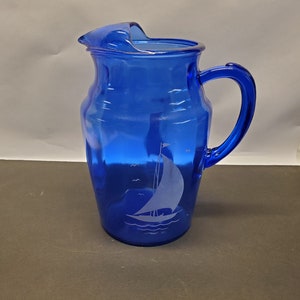 Vintage Cobalt blue sportsman series water pitcher with white sailboats with ice lip.