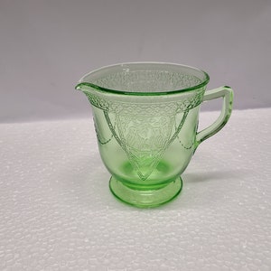 Green Georgian Lovebird Depression glass Tall  creamer has some ware and scratching.