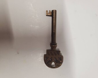 Fancy brass barrel furniture key 3" long.