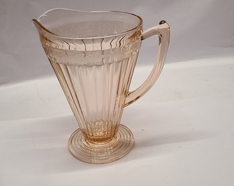 Pink adam depression glass pitcher with round base