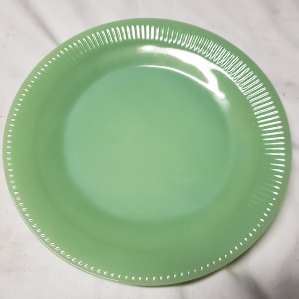 Fire- king jade-ite Oven Glass 9" Jane Ray Dinner plates. These do have the logo vintage.