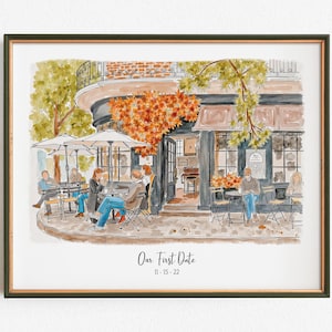 May include: Watercolor print of a cafe scene with people seated at outdoor tables under umbrellas. The artwork features a building with a curved facade, a floral arrangement, and the text "Our First Date 11-15-22". The print is framed.