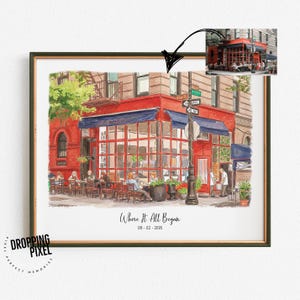 May include: Framed watercolor print of a red brick building with a blue awning and large windows. The print includes the text "Where It All Began" and the date 06-02-2016. The image is in a gold frame.