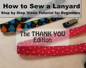 May include: Two fabric lanyards, one with a blue, green, orange and white diamond pattern and one with pink fabric with white polka dots. The text "How to Sew a Lanyard Step by Step Video Tutorial for Beginners The THANK YOU Edition" is displayed above the lanyards.