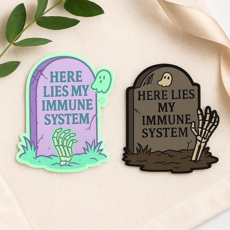 Funny spoonie sticker mockup with pastel Here Lies My Immune System design styled with a plant and spiral ribbon. Chronic illness humor vinyl decal displayed in cozy lifestyle flat lay.