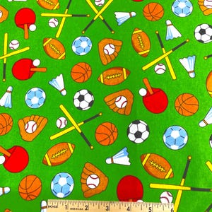May include: Green fabric with a repeating pattern of sports equipment. The design includes red ping pong paddles, baseballs, footballs, basketballs, soccer balls, baseball gloves, badminton shuttlecocks, and crossed baseball bats.