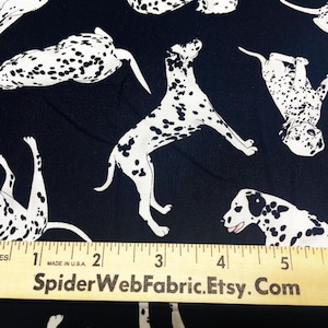 May include: Black fabric with a white repeating pattern of Dalmatian dogs. A ruler with the text "SpiderWebFabric.Etsy.Com" is placed on the fabric. The ruler measures 6 inches.
