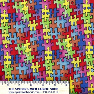 May include: A colorful fabric with a repeating pattern of puzzle pieces in various colors, including red, blue, green, yellow, and purple. The fabric is designed to look like a jigsaw puzzle.