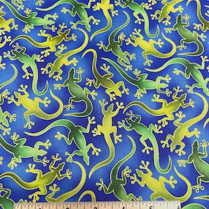 May include: Blue fabric with a pattern of green and yellow lizards. The fabric has a ruler with inches and the text "SpiderWebFabric.Etsy.Com".