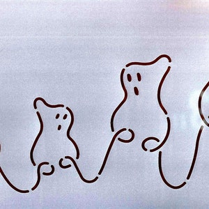 May include: A line drawing of four ghosts, each with a different size and shape, connected by a line. The ghosts are drawn in black on a white background.