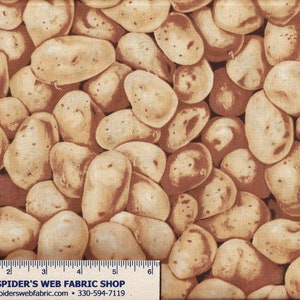 May include: A brown fabric with a repeating pattern of tan-colored potatoes. The fabric is textured and has a subtle sheen. The fabric is measured with a ruler that reads "The Spider's Web Fabric Shop" and a website address.