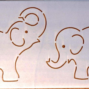 May include: A stencil of two elephants, one with its trunk raised and the other with its trunk down. The elephants are outlined in brown on a white background.