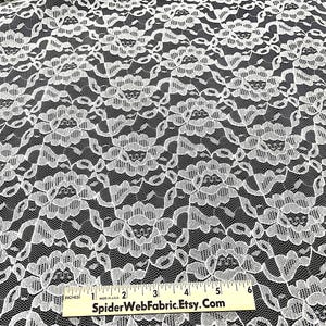 May include: White lace fabric with a floral pattern. The fabric is measured with a ruler that reads "SpiderWebFabric.Etsy.Com".
