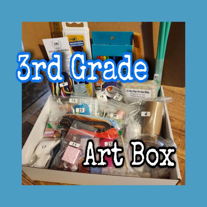 May include: A white cardboard box labeled 3rd Grade Art Box containing various art supplies in clear plastic bags, including yarn, air-dry clay, a cardboard tube, a clear ornament, and paint sets, all organized with numbered white adhesive labels.