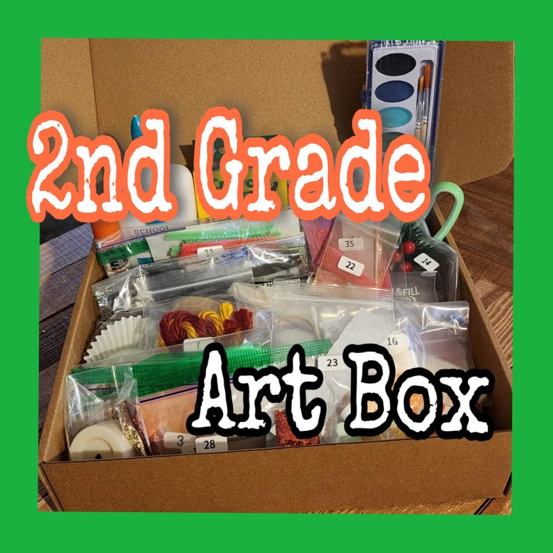 Może przedstawiać: Brązowe kartonowe pudełko z napisem "2nd Grade Art Box" wypełnione materiałami plastycznymi. Pudełko zawiera małe woreczki z r&oacute;żnymi przedmiotami, w tym farbami, pędzlami i innymi materiałami rzemieślniczymi. Tekst jest w zabawnym, pomarańczowym kroju pisma.