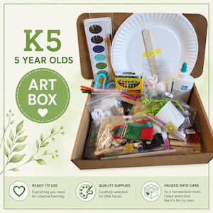 May include: A brown cardboard box filled with art supplies including a watercolor paint set, a white paper plate, a box of Crayola crayons, a bottle of school glue, wooden craft sticks, and various small plastic bags containing assorted craft materials.